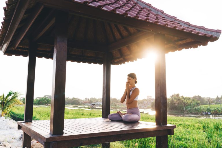 Side,view,of,calm,female,in,sportive,tracksuit,sitting,in